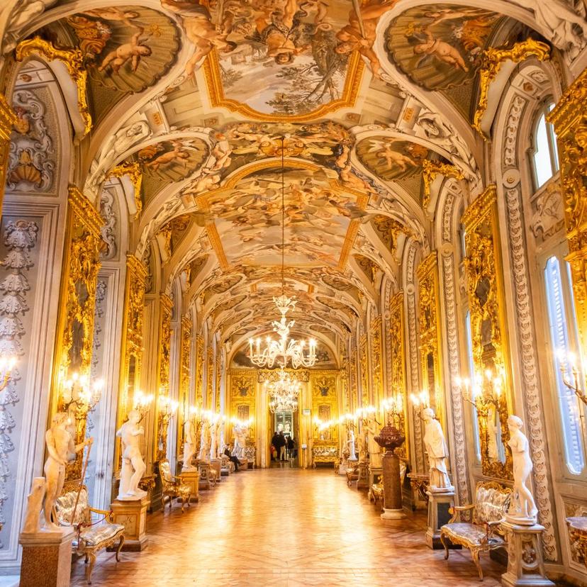 Historic atmosphere inside Villa Doria Pamphilj with statues, golden walls, and Renaissance frescoes