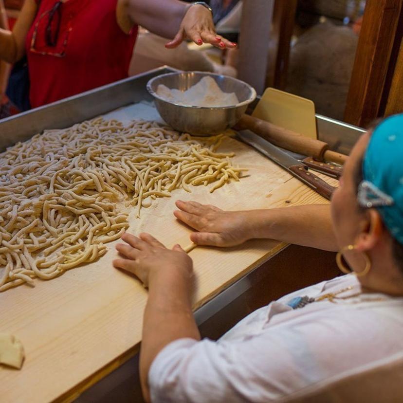 Restaurant staff making fresh pasta by hand in front of guests during a Trastevere food tour
