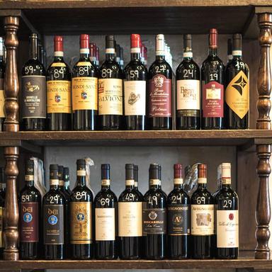 Wall of wine bottles on display inside a traditional wine bar in Rome during a wine tasting tour