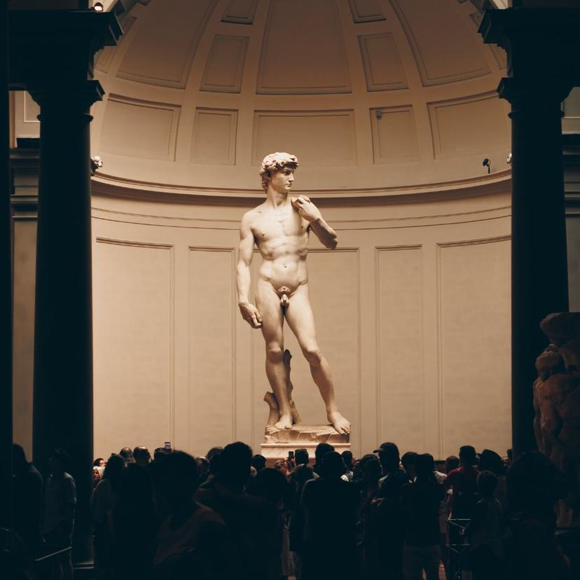 Tourists admiring Michelangelo's David at the Galleria dell'Accademia in Florence