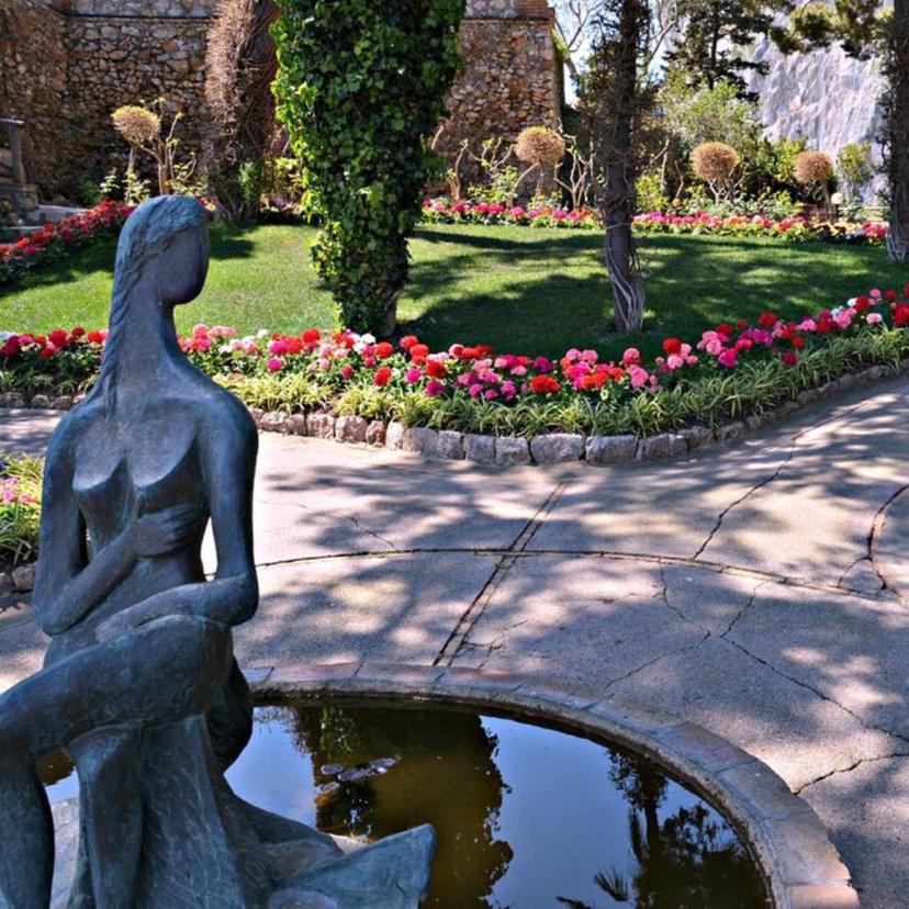Statue in park flowers fountain