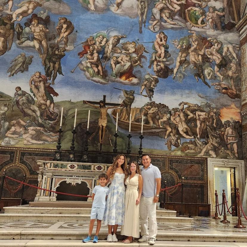 Family Inside Sistine Chapel Posing On Steps Artwork In Backround