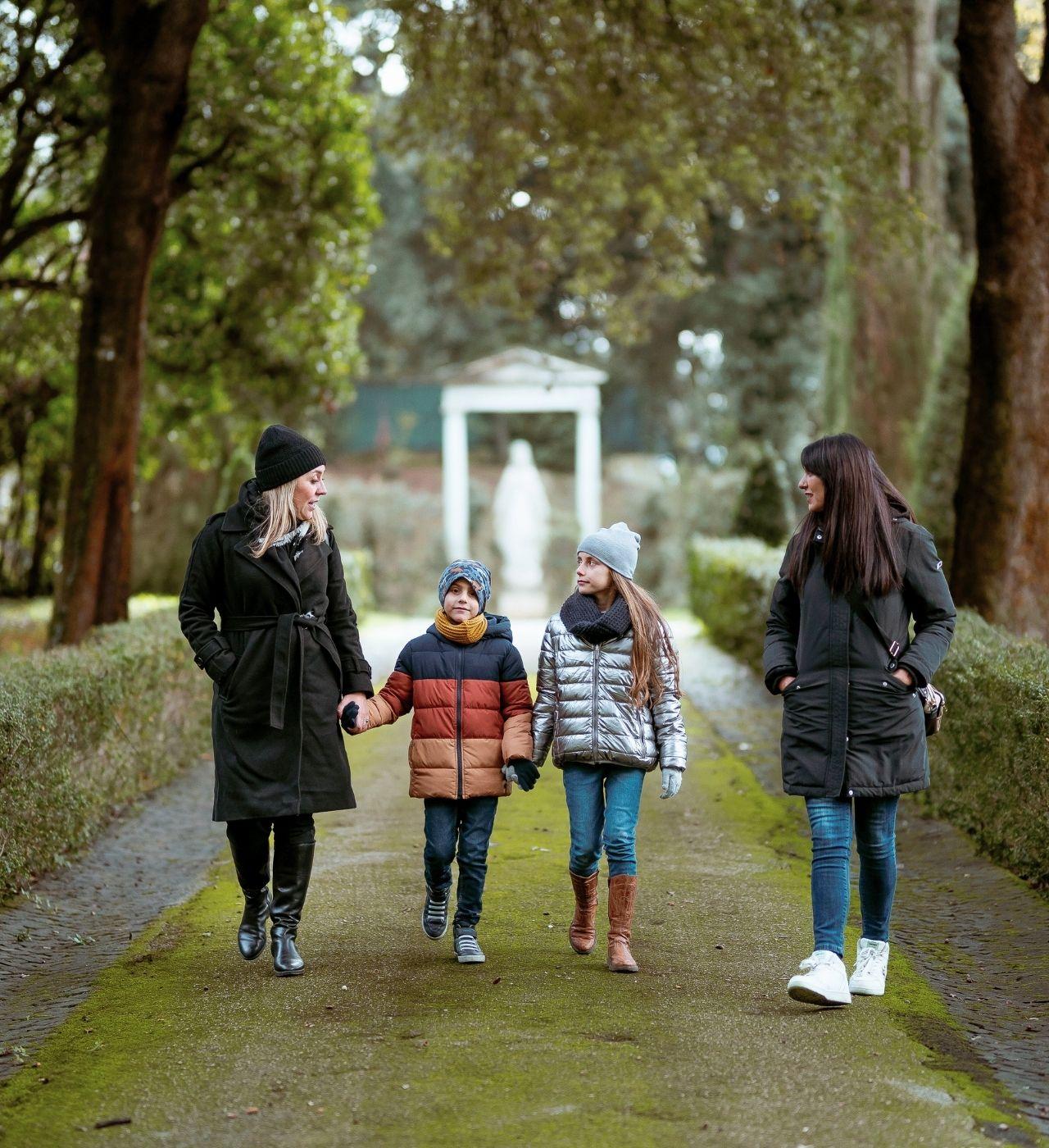 Family walking through the Papal Estate gardens in Castel Gandolfo during the Complete Papal Experience tour